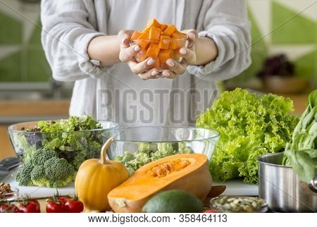 Vegetarian Concept. Unrecognizable Woman Preparing Healthy Salad In Big Glass Bowl With Fresh Pumpki