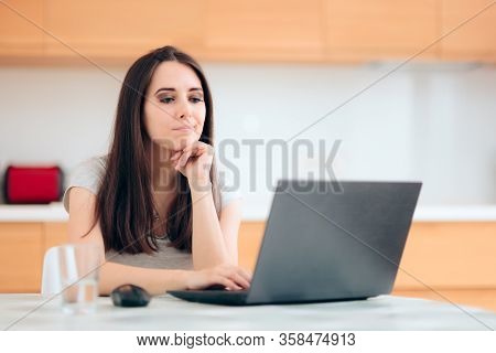 Worried Woman Reading The News At Home In The Kitchen
