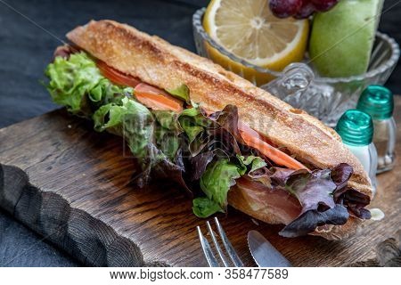 A Delicious Smoked Salmon Sesame Bread Sandwich On A Wooden Plate. It Is Perfect Eaten With Salads A