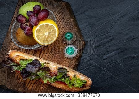 A Delicious Smoked Salmon Sesame Bread Sandwich With Fresh Fruit On A Wooden Plate. It Is Perfect Ea