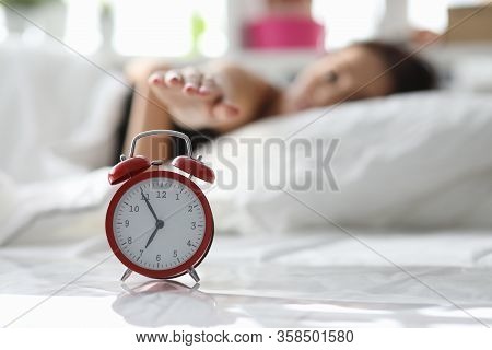 Girl Lies On Bed And Turns Off Alarm In Morning. Persistent Lack Sleep Destroys Motivation. Sleepy P