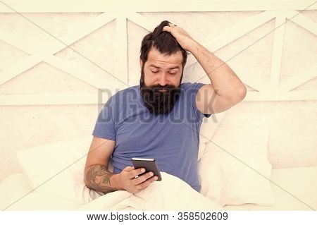 Checking Phone First Thing In Morning. Bearded Man Use Mobile Phone In Bed. Staying Mobile With Cell