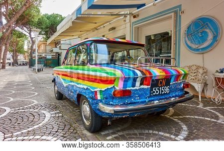 Cattollca, Rimini, Italy - February 29, 2020:  Colorful retro car NSU Prinz L parked next to Brandina store