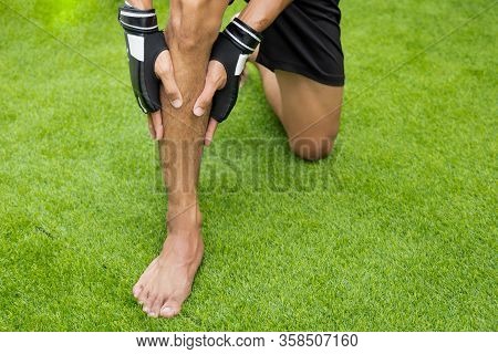 Close Up On Shin Injury. The Man Use Hands Hold On His Shin While Running