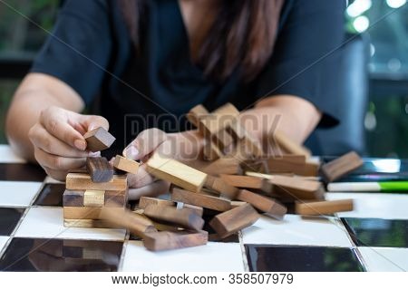 Growing Business Concept. Business Woman Picking Domino Blocks For Filling The Missing Dominus And P