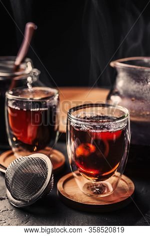 Cup Of Freshly Brewed Black Tea, Dark Moody, Tea Ceremony. Hot Water Is Poured From The Kettle Into 