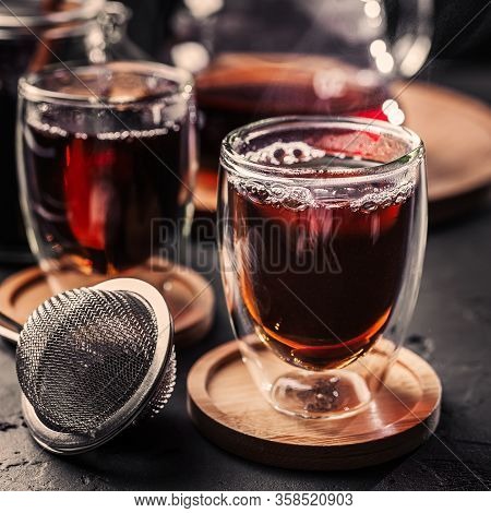 Cup Of Freshly Brewed Black Tea, Dark Moody, Tea Ceremony. Hot Water Is Poured From The Kettle Into 