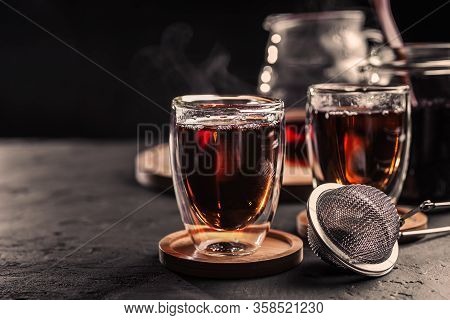 Cup Of Freshly Brewed Black Tea, Dark Moody, Tea Ceremony. Hot Water Is Poured From The Kettle Into 