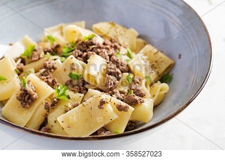 Pasta Calamarata With Minced Meat In Blue Bowl. Italian Cuisine.