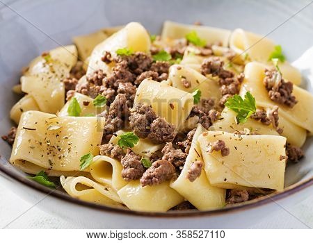 Pasta Calamarata With Minced Meat In Blue Bowl. Italian Cuisine.