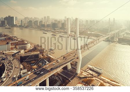 Shanghai Nanpu Bridge over Huangpu River with busy traffic in China.