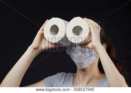 Young Girl In A Mask In A Panic Buys Toilet Paper
