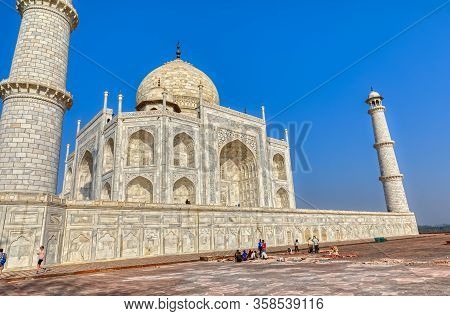 Agra, India - March 5 2018: Tourists Sighteseeing, Exploring And Admiring Famous The Taj Mahal While