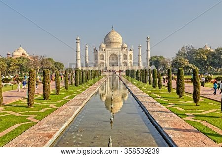 Agra, India - March 5 2018: Tourists Sighteseeing, Exploring And Admiring Famous The Taj Mahal