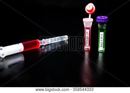 Syringe, Coronavirus In Vitro, Vactin In Vitro On A Black Background