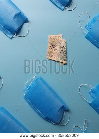 Czech Banknote Of 100 Korun And Masks On The Blue Background