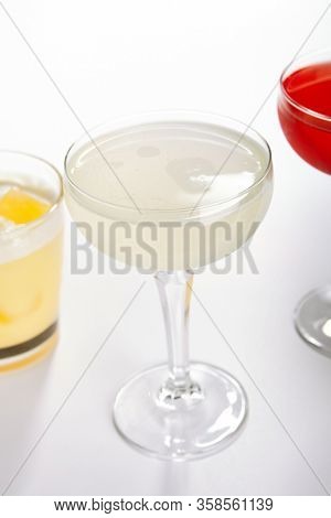 Tropical daiquiri cocktail close up. Alcohol strong drink in glass side view. Beverage with rum and fruit juice in drinkware. Summer beach exotic cocktail portion with crushed ice in glassware
