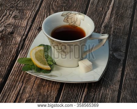 Tea Cup With Sugar And Mint On Wooden Background