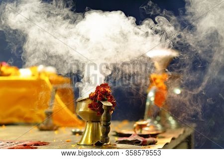 Incense burning and flowers of French Marigold for the Ganga Aarti ceremony in Varanasi, India
