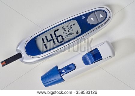 Diabetes, Glucometer With Glucose Measurement On Screen And Blood On Test Strip