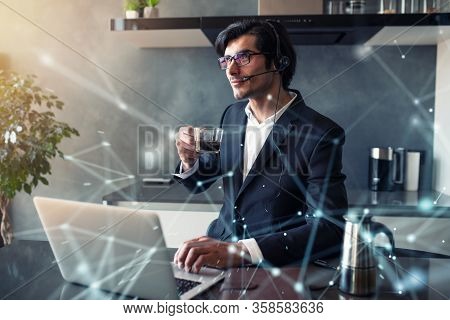 Businessman Works From Remote At House With A Laptop Due To Coronavirus Quarantine.