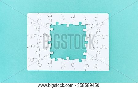 Unfinished jigsaw puzzle on blue background