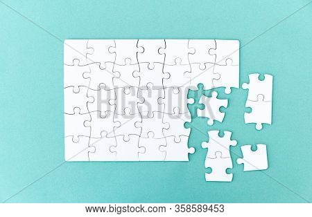 Unfinished jigsaw puzzle on blue background
