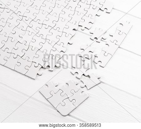 Matching pieces of empty puzzle on white background