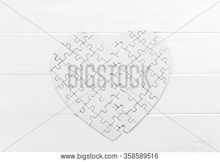 Bold heart shaped puzzle on white table