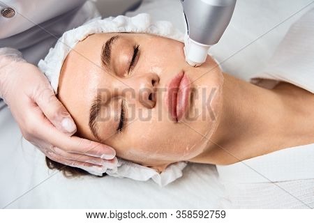 Face Skin Care. Close-up Of Woman Getting Facial Hydro Microdermabrasion Peeling Treatment At Cosmet