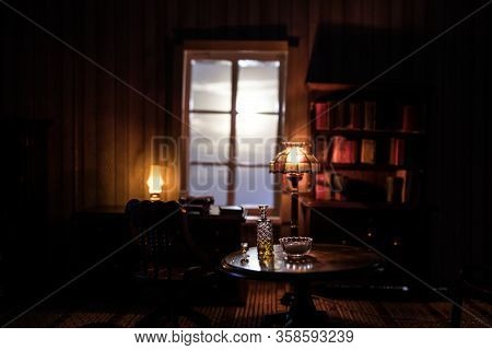 A Realistic Dollhouse Living Room With Furniture And Window At Night. Artwork Table Decoration With 