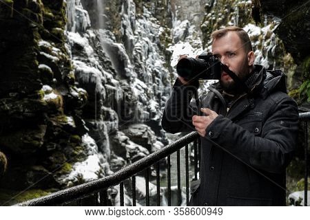Tourist with a camera in Bordalsgjelet gorge in Voss, Norway.