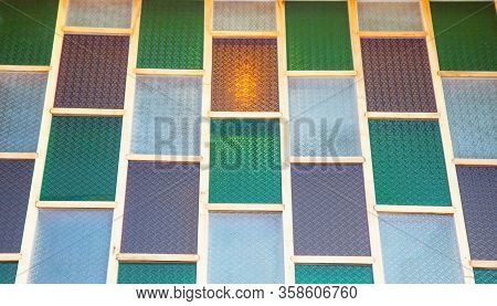 Image Of A Multicolored Stained Glass Window. Uneven Glass Surface Background Image. Window Oak Bark