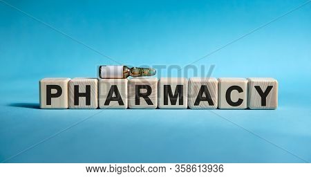 Pharmacy - Text On Cubes. Drug In Ambula To Reduce Disease Symptoms On A Blue Background