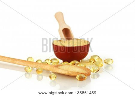 Gelatin in a bowl and wooden spoon on white background close-up
