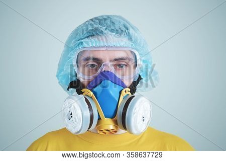 Man In Protective Face Mask, Eyeglasses And Head Protection. Medical Personell, Scientist Or Md In W