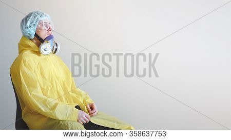 Tired Medical Worker In Protective Gear Resting After A Shift. Concept Of Covid-19 Epidemic, Healthc