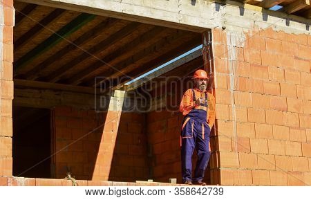 Well Done. Repairman Tired Builder Relaxing At Construction Site. Builder Smoking Cigarette. Break A