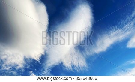 Blue Sky Background With White Dramatic Colorful Clouds And Sunlight, Vast Sky Background. Picturesq