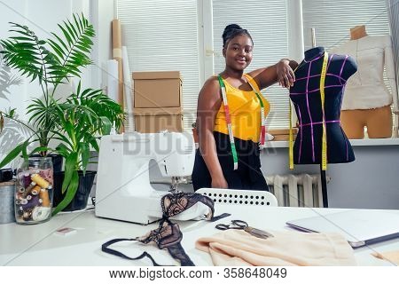Afro Woman Drawing Pattern Plotting Paper In Workshop