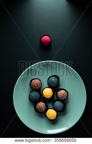 Colored Round Candies On A Plate On A Dark Background. Flatlay.
