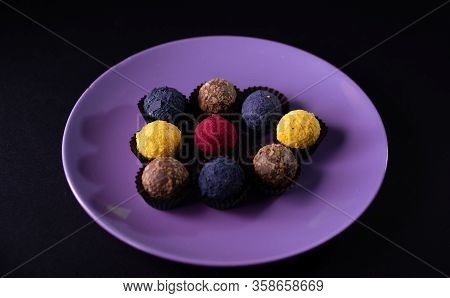 Colored Round Candies On A Plate On A Dark Background. Flatlay.