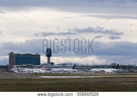 Richmond, Bc, Canada - Mar 29, 2020: Air Canada Aircraft Parked On The Tarmac With Yvr Airport In Th