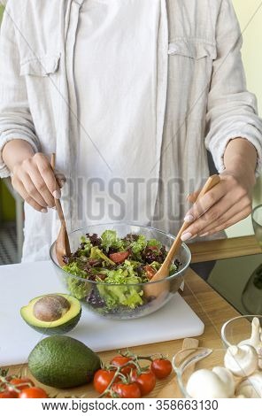 Stay At Home And Eat Healthy Food With Vitamins. Woman Preparing Vitamin Vegetable Salad At Home, Ve