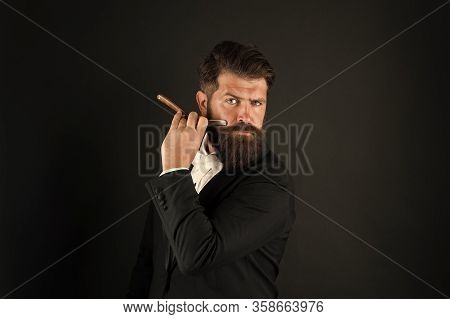 Barbershop For Gentlemen Only. Businessman Hold Barbers Tool Dark Background. Bearded Man Shave In B