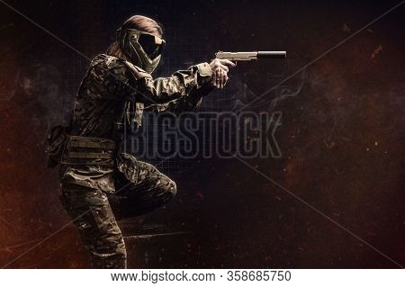 Paintball. Female Recon Fighter With Gun. Background.