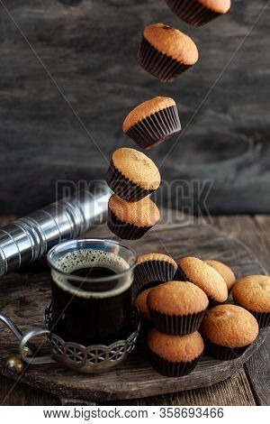 Flying Muffins Fall Into A Cup Of Coffee. Flying Food.