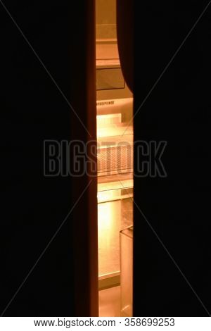 Light Sift Out From Refrigerator Door Ajar Out In The Dark