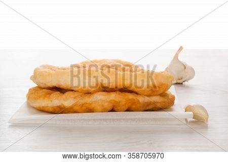 Traditional Hungarian Food Specialty Langos With Garlic On White.
