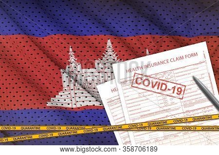 Cambodia Flag And Health Insurance Claim Form With Covid-19 Stamp. Coronavirus Or 2019-ncov Virus Co